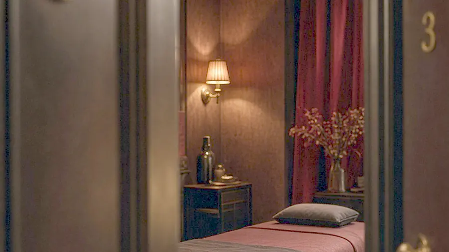 Adult massage near me - oiled bare back on a massage table in candlelight