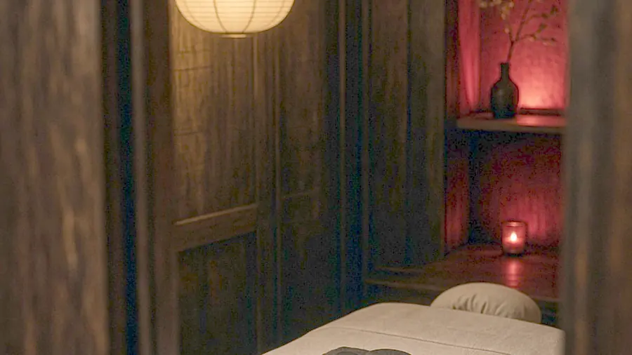 Asian massage near me - oiled bare back on a massage table in candlelight