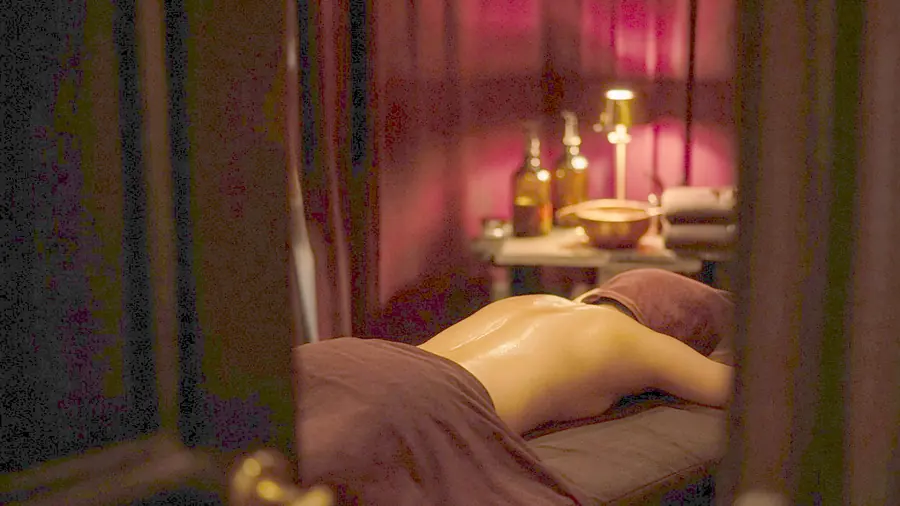 Body to body massage near me - oiled bare back on a massage table in candlelight