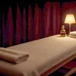 Full body massage near me - a candlelit room and a body oiled for a session