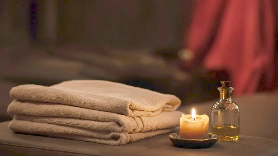 Happy ending massage near me - a candlelit room and a body oiled for a session