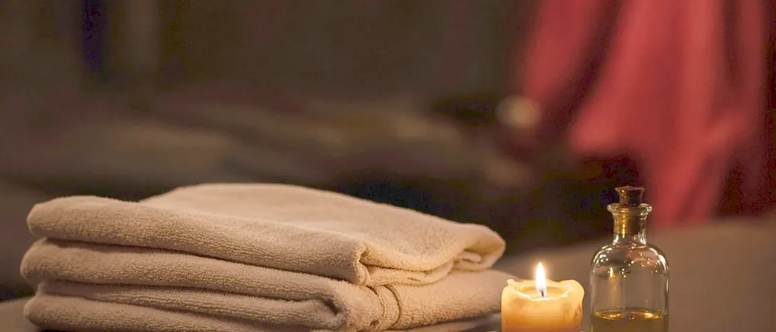 Happy ending massage near me - a candlelit room and a body oiled for a session