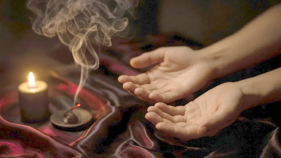 Lingam massage near me - a candlelit room and a body oiled for a session