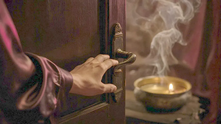 Lingam massage near me - warm oil poured over bare shoulders at the start of a session