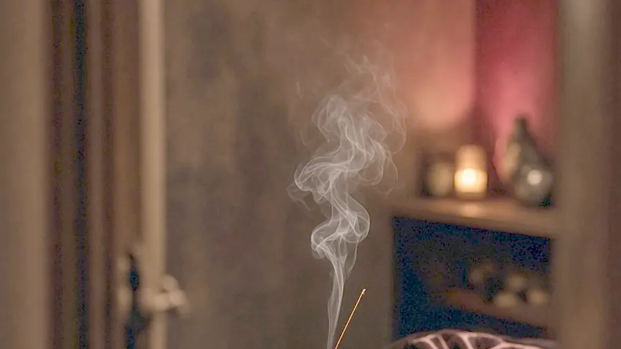 Lingam massage near me - oiled bare back on a massage table in candlelight