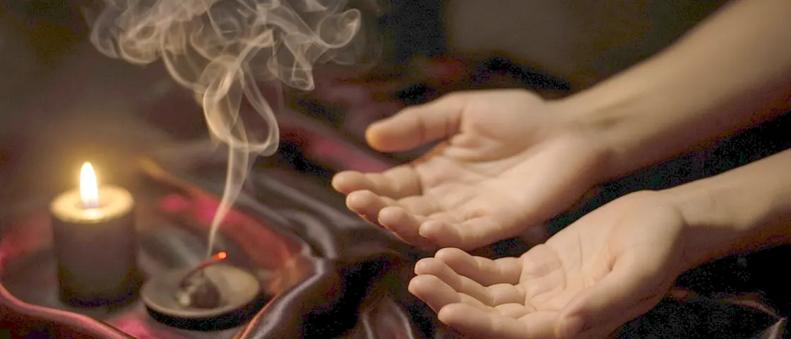 Lingam massage near me - a candlelit room and a body oiled for a session