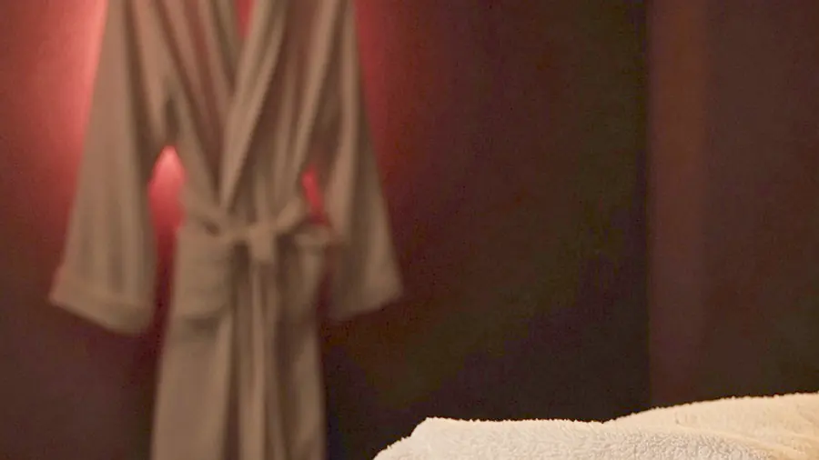 Nude massage near me - a candlelit room and a body oiled for a session