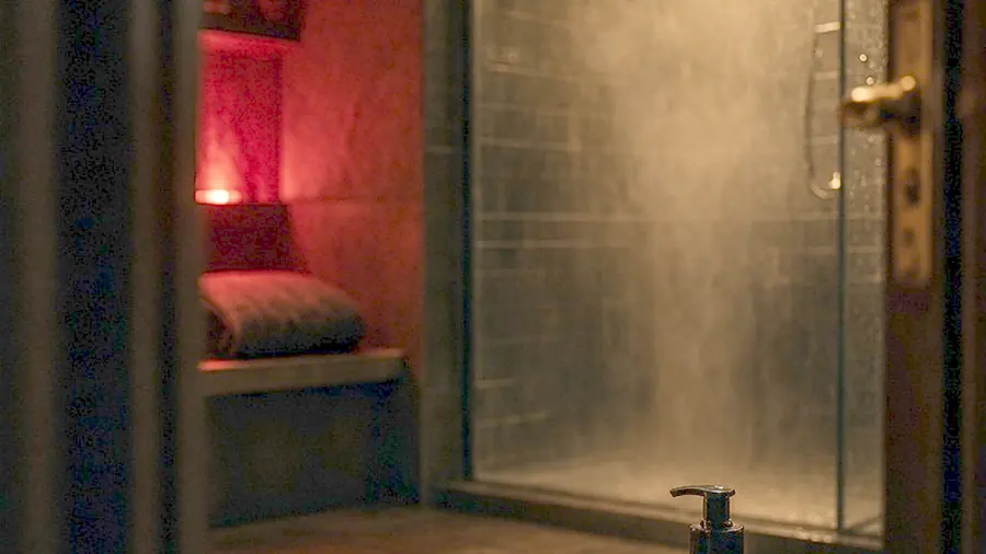 Nuru massage near me - oiled bare back on a massage table in candlelight