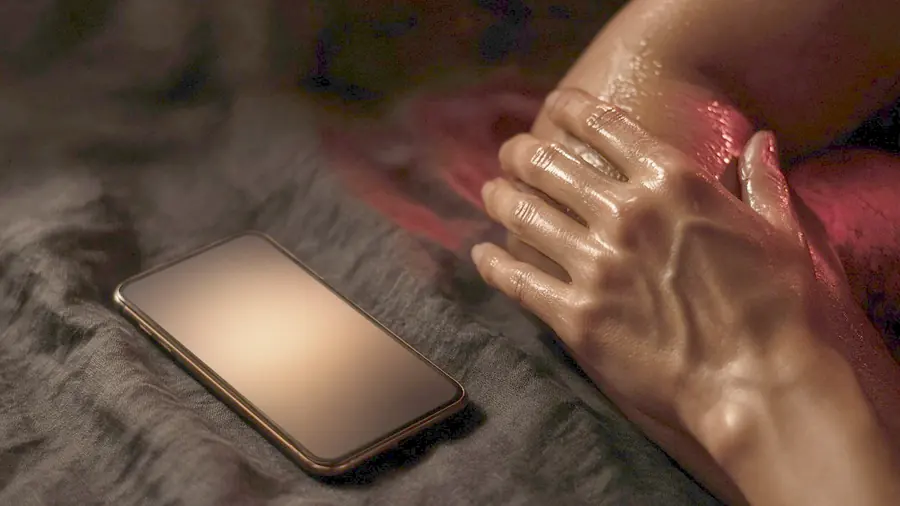 Sensual massage near me - venue listing open on a phone beside draped silk and bare skin