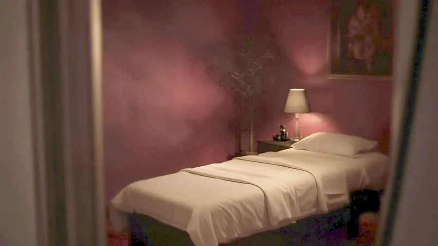 Sexual massage near me - oiled bare back on a massage table in candlelight