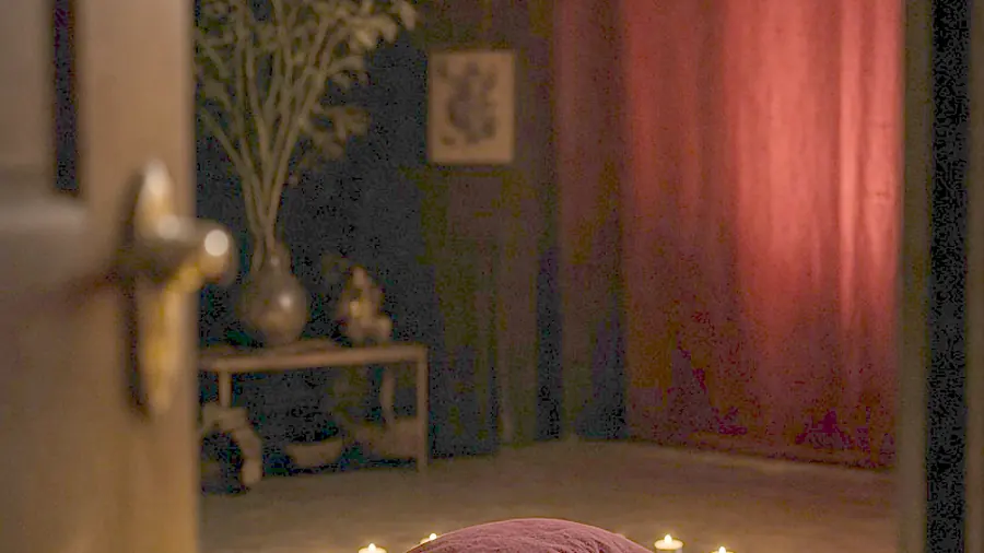 Tantric massage near me - oiled bare back on a massage table in candlelight